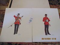 Two military uniform prints shown side by side, each featuring a soldier in red ceremonial attire. Prints have minor wear on edges seen.