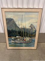 Full view of the framed painting showing sailboats on water with a mountain landscape in the background.