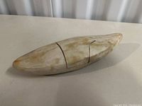 Side view showing elongated oval boat shape with interlocking removable panels