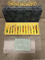 Full shot of the unopened decorative candle set in its box with protective packing material.