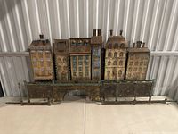 Front view of entire metal cityscape sculpture on table