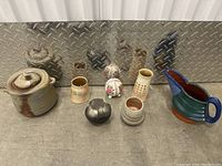 Full lot of 7 items on concrete floor with metal diamond plate background showing diverse shapes and colors.