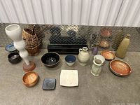 Image showing entire lot with all pottery pieces arranged and visible, including bowls, plates, and vessels of various shapes and colors.