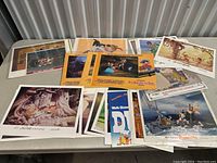 Photo showing assortment of vintage Disney lobby cards and prints spread out on table