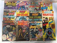 All 12 DC comic books laid out together showing various titles and colorful vintage superhero covers.