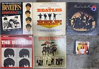 Overview of five Beatles vinyl albums and one George Harrison CD on a surface, showing covers clearly