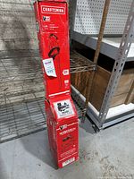 Photo of Craftsman V20 hedge trimmer box standing on a metal shelf, showing full box length with visible label and branding.