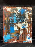 Front view of the signed abstract oil painting on canvas with mixed colors including blue, white, black, rust, and red circular motif near bottom right.