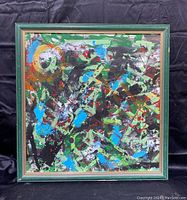 Full view of the framed abstract painting showing vibrant colors and composition.