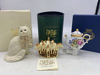 Front view of all three items: Harmony Kingdom horse trinket box, Lenox cat figurine, and Sorelle plug-in night light with original box and instruction booklet.