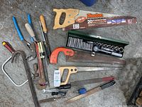 Full overview of tools including saws, clamps, files, and socket set in green case.