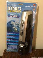 Front view of the Bell + Howell Ionic Whisper air purifier in sealed packaging highlighting the product and its features.