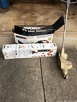 Photo of Worx Trivac blower/vac/mulcher in box with Craftsman edger and boxed Worx cordless trimmer