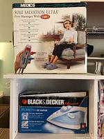 Boxed Homedics Sole Salvation Ultra Foot Massager with Heat and 3-speed massage, showing usage image and product details.