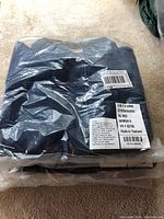Four folded L.L. Bean women’s denim jackets in sealed plastic packaging showing size label and barcode.
