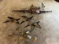 Photo showing the entire set of five metal art pieces including three flying ducks, farm landscape, and golden leaf branch
