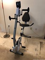 Full view of Stamina recumbent bike showing silver frame, padded seat and backrest, and digital display console.