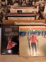 Box of vinyl records including Tchaikovsky classical ballets and Johnny Mathis Christmas album visible at front