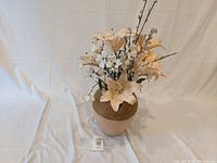 Full view of the decorative vase with artificial flowers arranged inside, showing height and texture