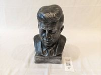 Front view of John F. Kennedy bust showing detailed facial features and inscription on the base.