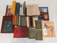 Wide view of large literature book lot showing multiple rows including leatherbound and hardcover books.