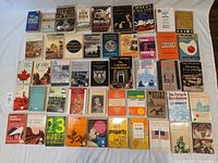 Top view of about 40 paperback history books arranged side-by-side and stacked in some rows. Covers display titles on topics such as New York, Modern England, Russia, The French Revolution, World Prehistory, and more.