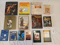 Wide shot showing entire lot of 14 mythology and fairy tale books with varied covers and sizes.