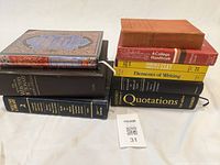 Cluster of six reference books stacked on white cloth, showing spines and top covers, for full lot overview.
