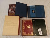 Photo of six reference books including The Timetables of History and Canadiana Encyclopedia