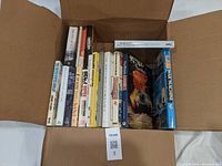 Box filled with about 20 mostly hardcover books on World War II, showing titles and spines for identification.