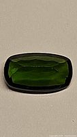 Front view of deep green octagon cut chrome diopside gemstone showing rich color and clarity.