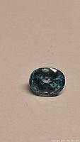 Front view of the natural lagoon blue oval cut zircon gemstone showing color and facets.
