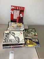 Photo showing stacked books including multiple Far Side volumes and Calvin and Hobbes books on a flat surface.