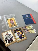 Lot layout including Maurice Richard Beehive card in protective sleeve, Luc Robitaille and Marcel Dionne framed 5x7 hockey cards, two Toronto hockey event tickets, and a stamp folder.