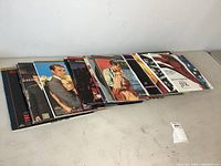 Photo showing a row of 16 laserdiscs with mostly movie covers and some music covers visible