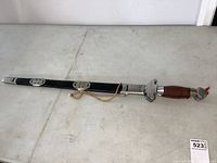 Black lacquered sheath with silver-tone fittings and attached cord