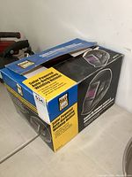 Box of Power Fist Solar Powered Auto-Darkening Welding Helmet showing product branding and image