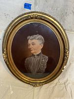 Full frontal view of oval painting and carved gilt frame