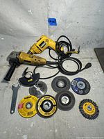 Full shot of the DeWalt drill and grinder with the assortment of cutting, grinding, and brush accessories.