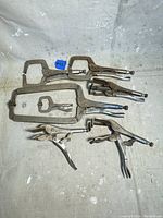 Full lot of 8 assorted Vise Grip locking pliers and clamps on a fabric surface