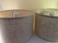 Two beige linen shade hanging pendant lights, showing fabric texture and shape.