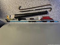 Full view of all items including two crow bars, extendable car cleaning tool, and water blaster attachment in packaging