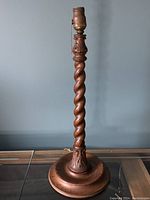 Full view of the handcrafted oak barley twist lamp showing the tall twisted shaft, upper socket with pull chain, and round wooden base.