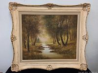 Frontal photo of the framed painting showing the entire artwork and frame details.