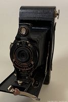 Front view of Eastman Kodak No. 2A camera showing folding bellows and lens shutter assembly.