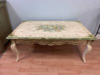 Front view of the wooden coffee table showing the full rectangular top and curved legs