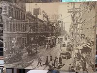 Full front view of large black and white canvas print showing busy Yonge Street with early 1900s streetcars and pedestrians in period clothing.