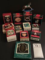 Photo showing a variety of Hallmark Christmas ornaments with packaging, including a rocking horse figure and multiple boxed ornaments with holiday themes.