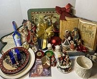 Full lot of assorted Christmas decorations including figurines, plates, gift box, and DVD