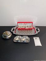 Full view of all items included: tray, sugar dish, two-compartment dish, boxed salt shakers